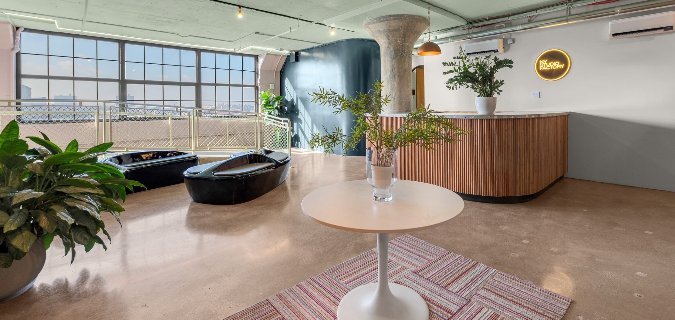 NYSF Sunset Yards lobby — raw floor plate converted into 60 sound-isolated studios