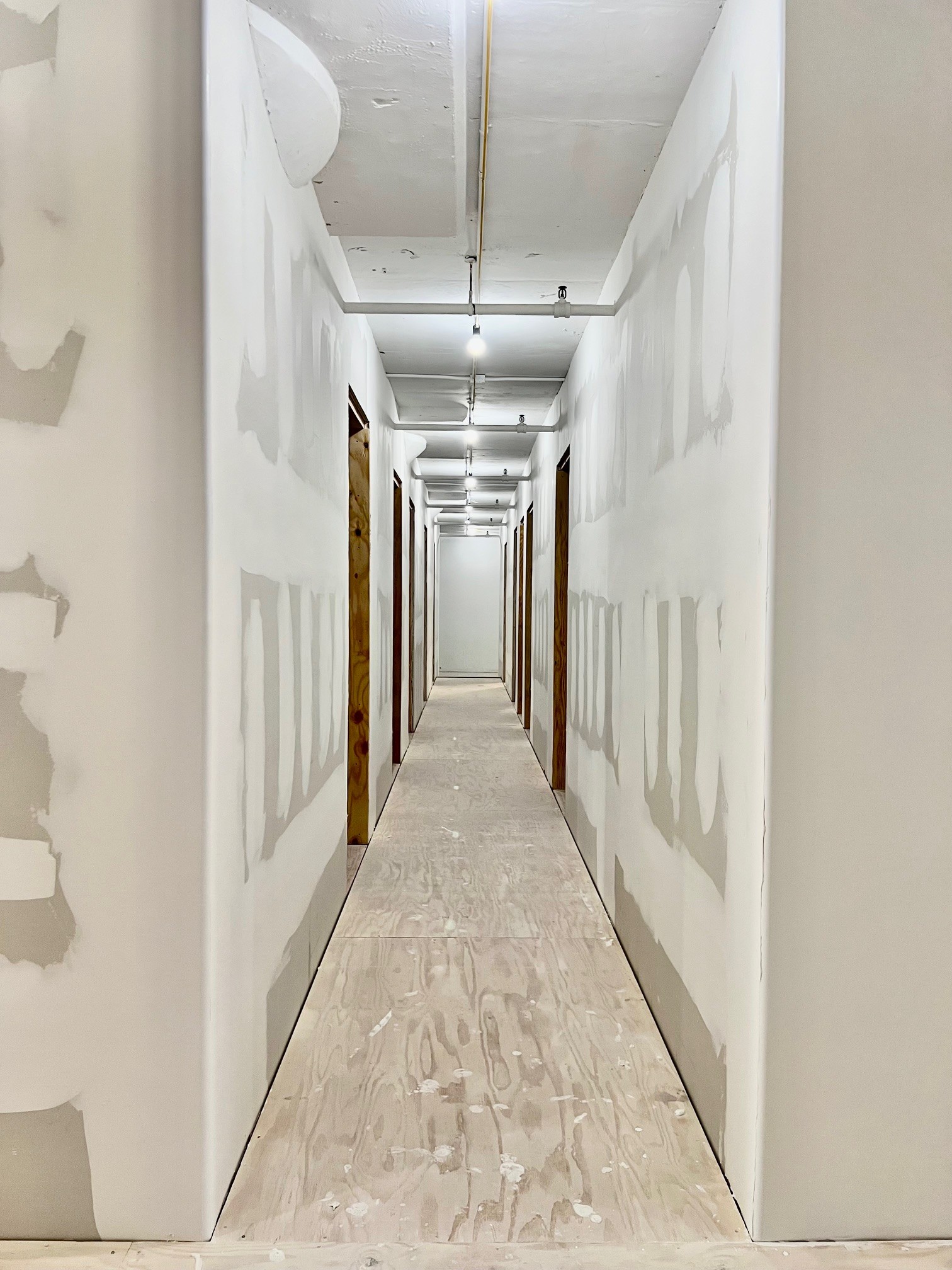 A finished PRYM interior — studio corridor at NYSF Sunset Yards