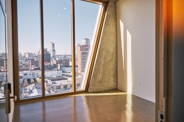 Creative studio with dramatic angular glazing and skyline views inside a five-star Brooklyn hotel